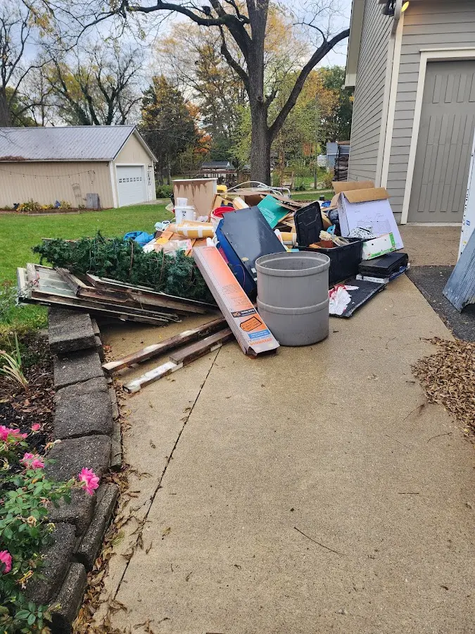 Dumpster being loaded with debris for 10 Yard Dumpster Rental in Bethel